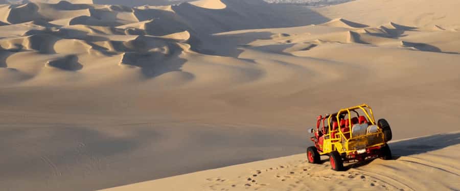 Huacachina: Sandboarding and 4x4 Desert Adventure - Sliding down the dunes