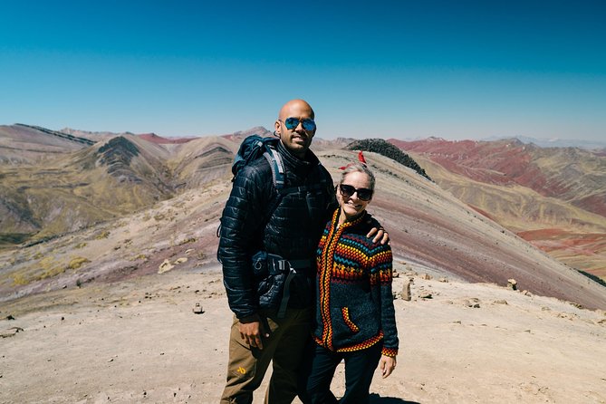 Private Palccoyo Rainbow Hike Without the Crowds - Walking with an alpaca toward three colorful peaks